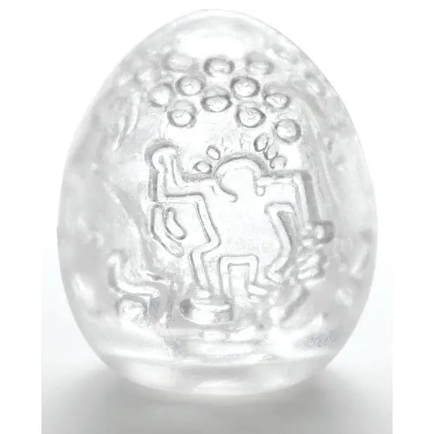 Clear egg-shaped Keith Haring Tenga object with abstract etched figures and circles