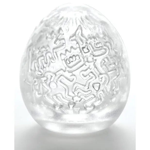 Transparent Keith Haring Tenga Egg with intricate etched designs for unique pleasure