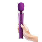 Hand holds purple Le Wand Petite Rechargeable Massager