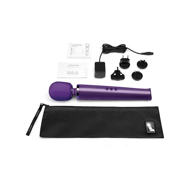 Purple hair dryer with black bag beside Le Wand Rechargeable Massager - Black