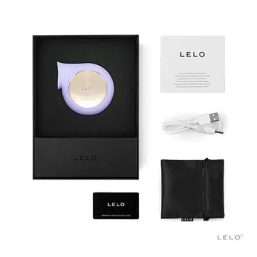 Close-up of box with cell phone, wallet, and LELO SILA CRUISE Sonic Clitoral Massager