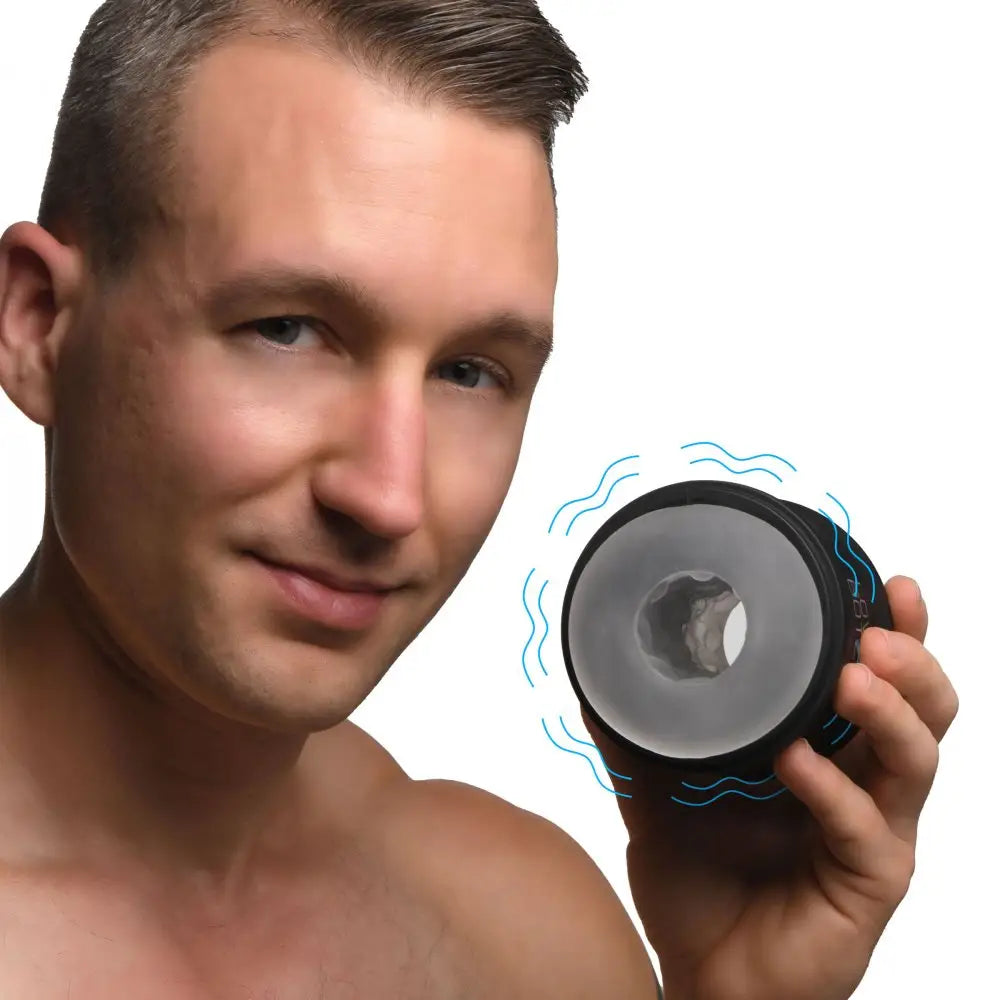 Shirtless man using LoveBotz 10X Cyber Stroke Vibrating Masturbator for double stroker relief