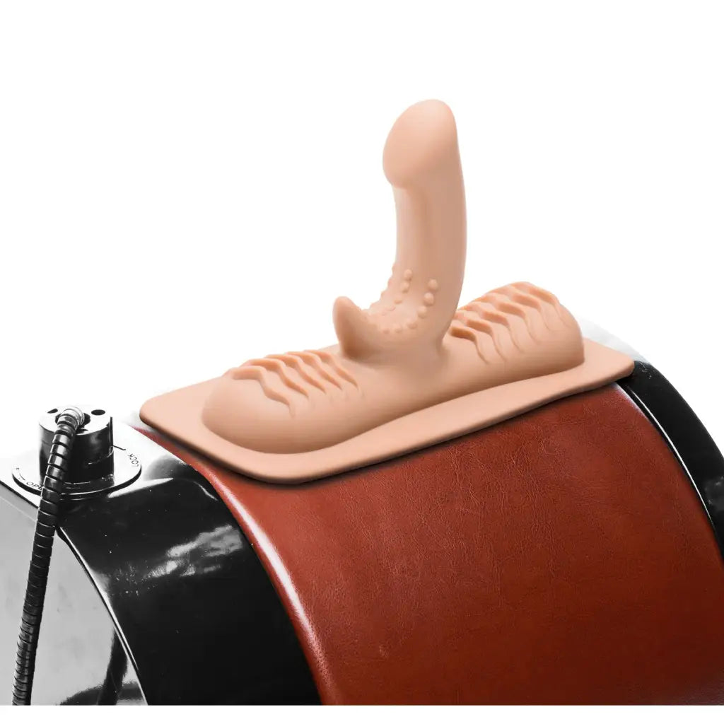 Hand on LoveBotz G-Spot attachment for saddle sex machine in a playful demonstration