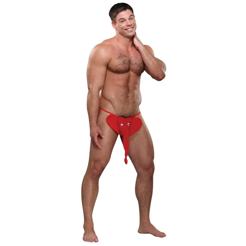 Muscular man in red novelty squeaker elephant G-string with trunk design