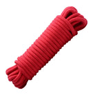 Coiled red Master Series cotton bondage rope, perfect for secure and comfortable restraint