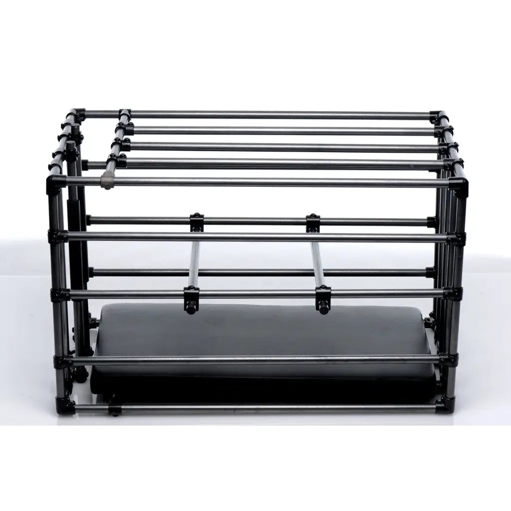 The Master Series Kennel Adjustable Puppy Cage with Padded Board next to a large printer machine