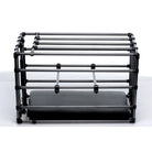 The Master Series Kennel Adjustable Puppy Cage with Padded Board next to a large printer machine