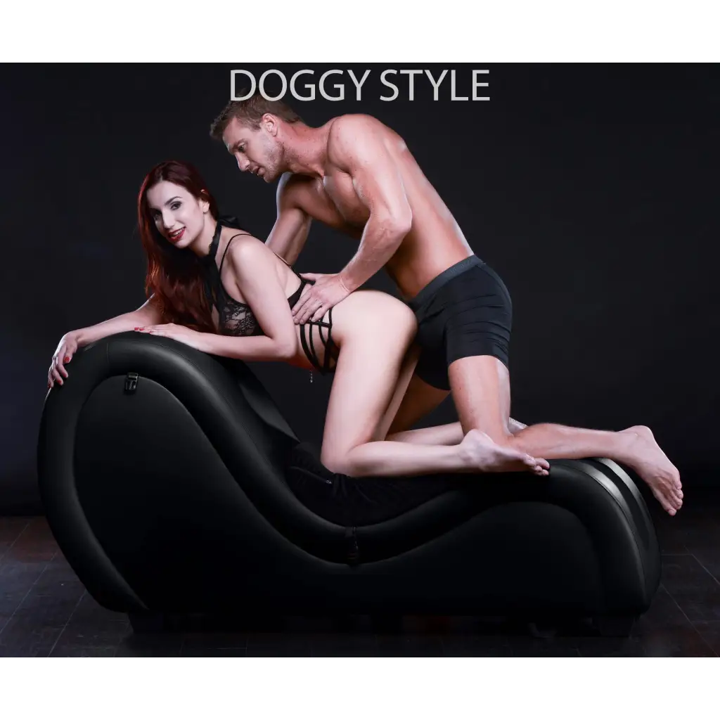 A man and woman sitting on the Master Series Kinky Couch Sex Chaise Lounge in a cozy setting