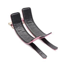 Black leather wrist restraints with pink trim from Master Series Snake Print Bondage Set