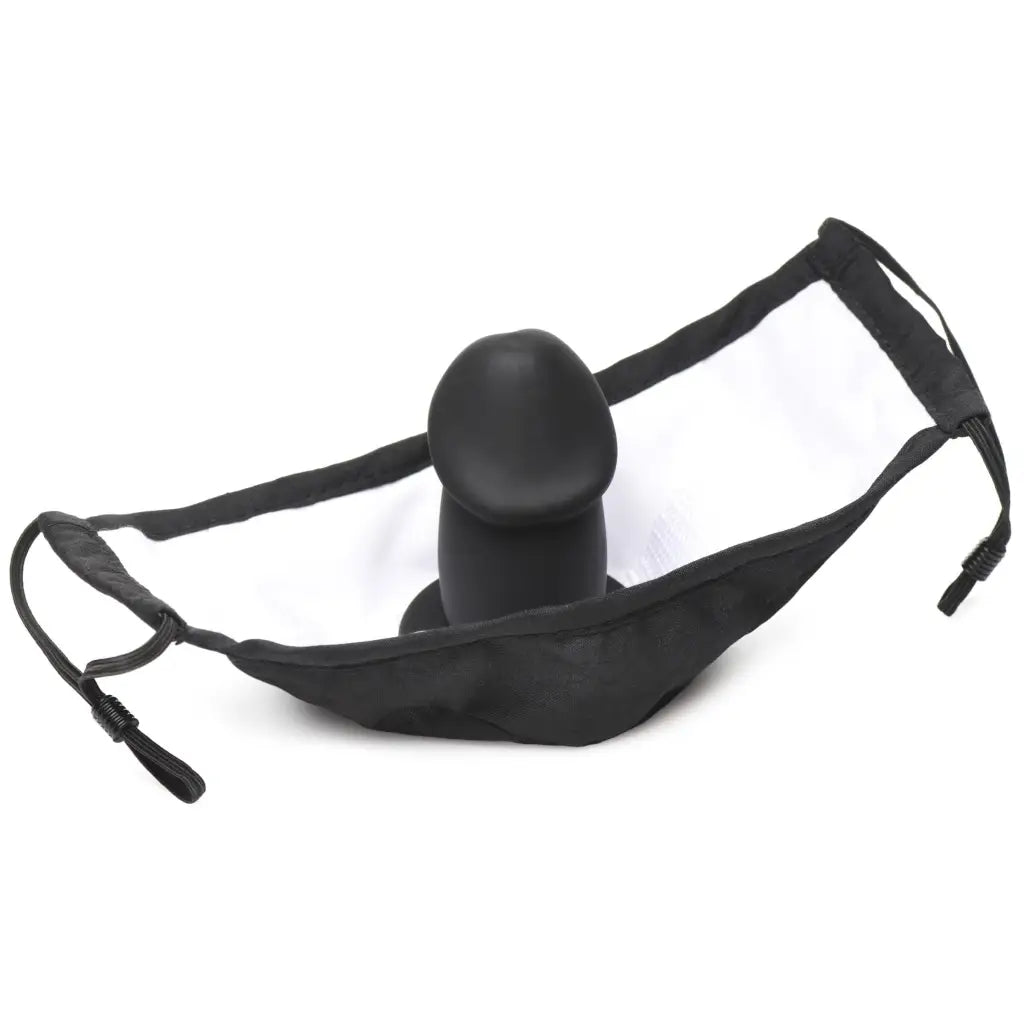 Black strap-on dildo with adjustable harness featured in the Mouth-full Dildo Face Mask