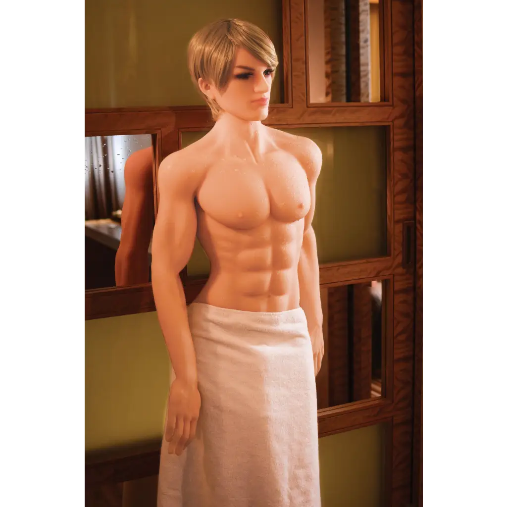 A man in a towel stands beside a mirror with NextGen Dolls Kenny Premium Love Doll