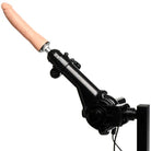 A hand holding a microphone next to an Obedience Chair With Sex Machine and arm pads