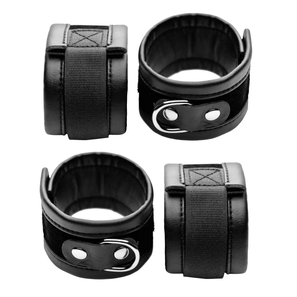 Black leather wrist cuffs with metal hardware; part of our On Your Knees Bondage Kit