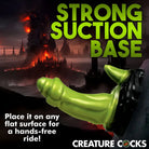 Poster of green hand holding a gun, promoting Orc Silicone Dildo with suction cup base