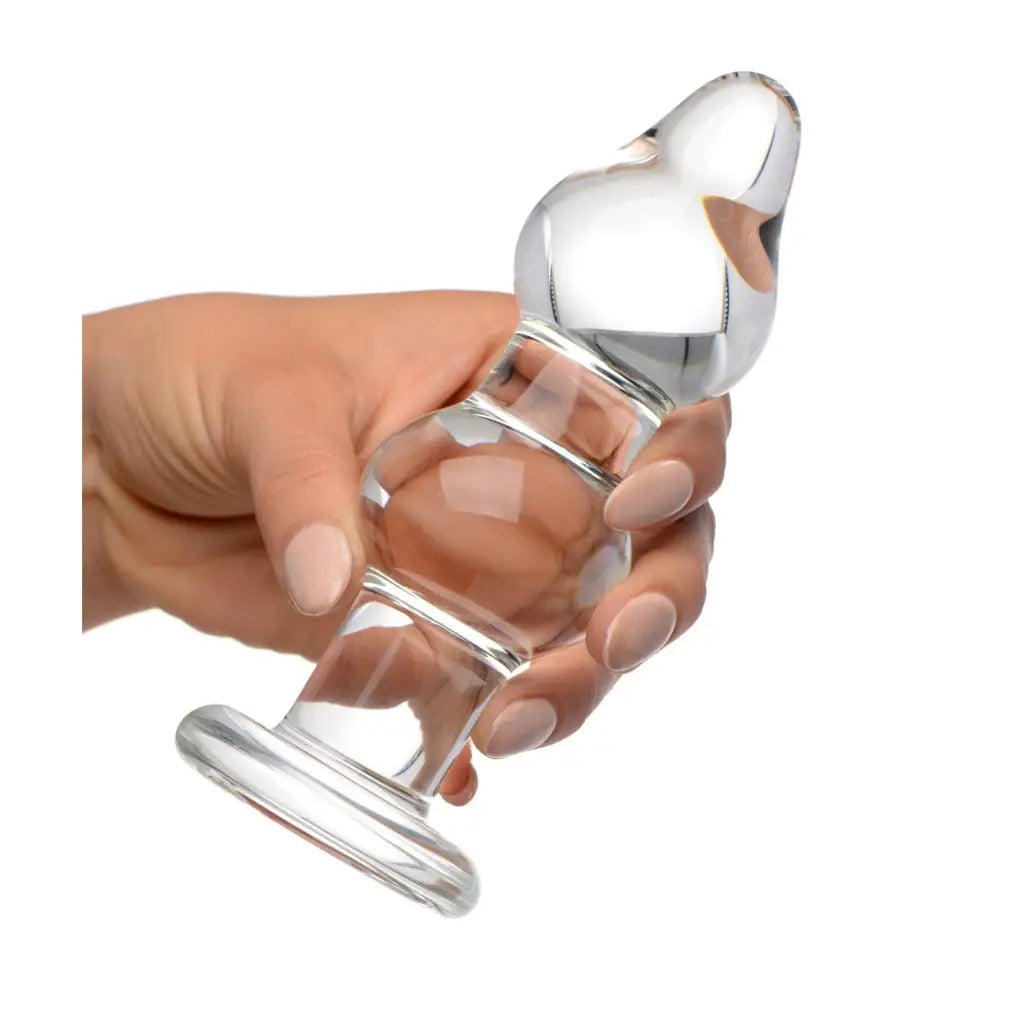 Hand holding Param Glass Anal Plug with a flared base for safe use and comfort