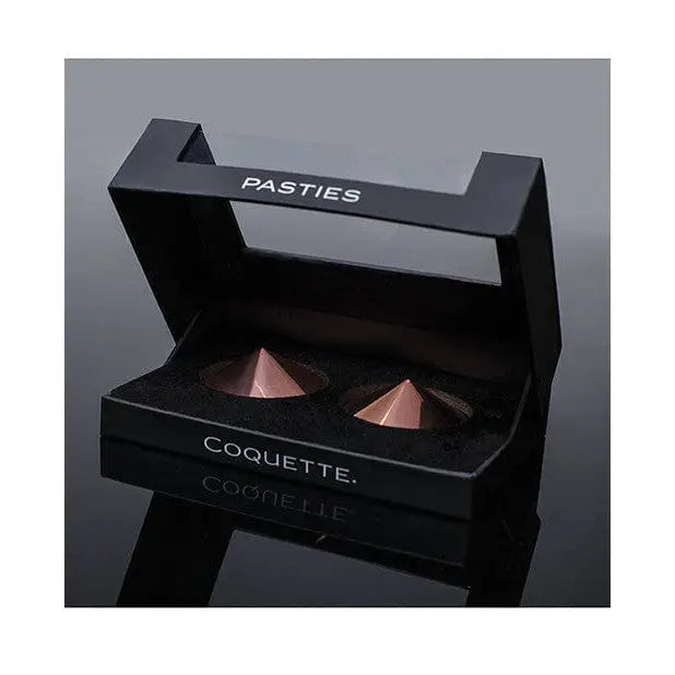 Black box with rose-gold cone pasties labeled ’Coquette’ from Pleasure Collection Metal Pasties