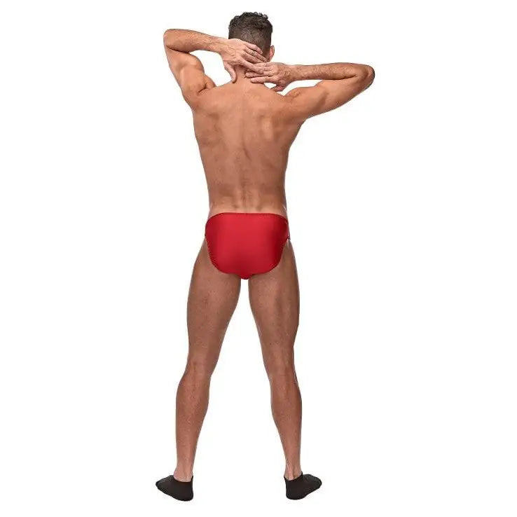 Muscular man in red Pouchless Brief O/s and black socks, showcasing nylon spandex appeal