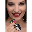 Smiling woman with red lipstick holding Booty Sparks Rainbow Prism Gem Anal Plug