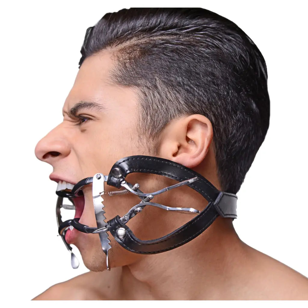 Man wearing Ratchet Style Jennings Mouth Gag With Strap for restraining purposes