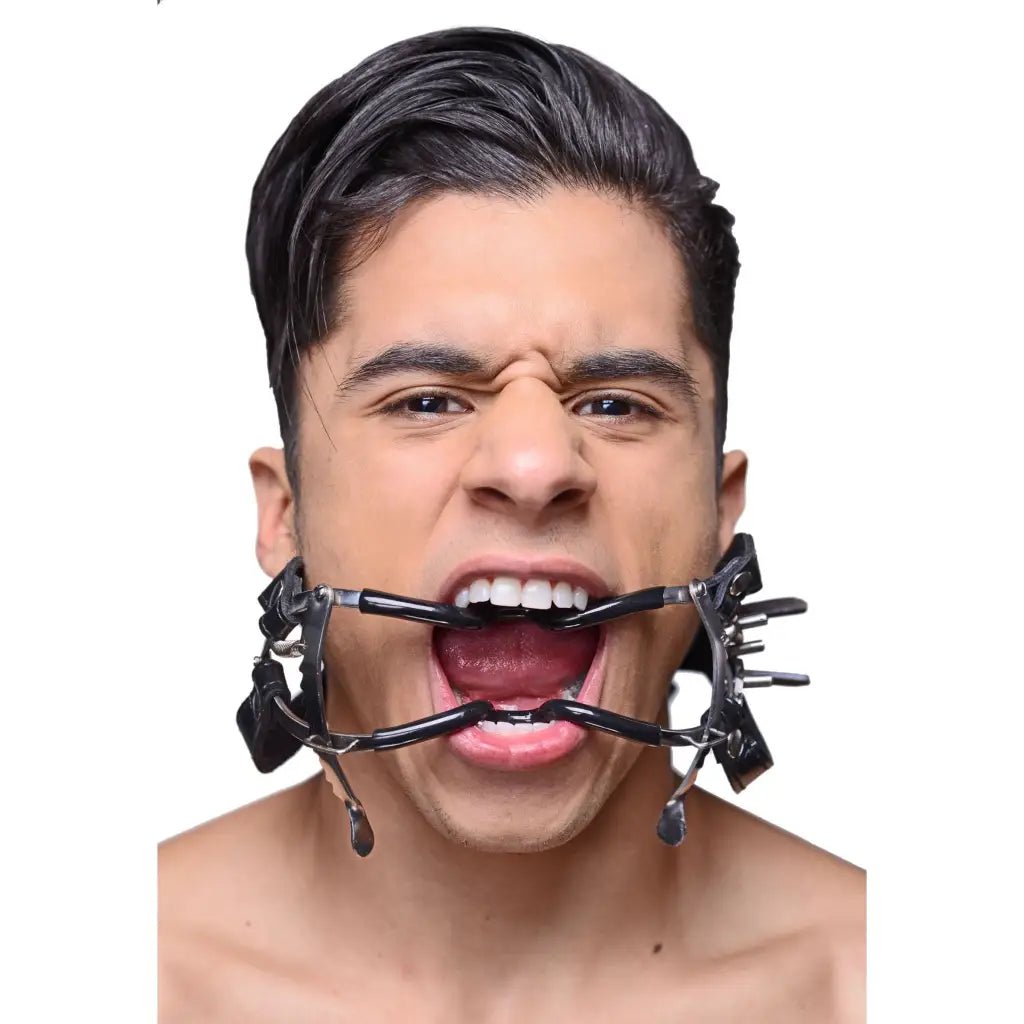 Man using Ratchet Style Jennings Mouth Gag With Strap for BDSM or medical purposes