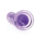 Purple glass plugs next to RealRock Crystal Clear Straight 7 in. Dildo Without Balls Purple