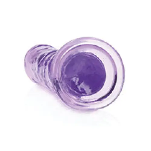 Purple glass plugs next to RealRock Crystal Clear Straight 7 in. Dildo Without Balls Purple