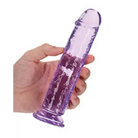 A hand holding a purple RealRock Crystal Clear Straight 7 in. Dildo Without Balls