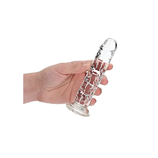 Hand holding RealRock Crystal Clear Straight 7 in. Dildo in purple, white background