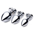 Red Heart Gem Anal Plug Set featuring three shiny metal knobs on a white surface