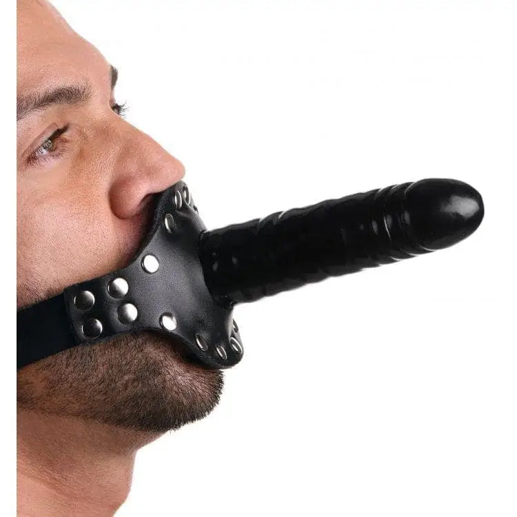 A man wearing the Ride Me Mouth Gag shows its inch insertable length and inch max diameter