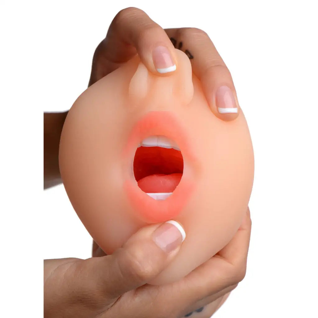 Human hands holding Sarahs Sexy Mouth Stroker, a flesh-colored silicone open mouth model