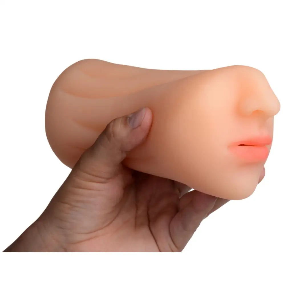 Artificial mask held by a hand, featured in Sarahs Sexy Mouth Stroker product