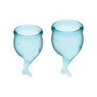 Two blue wine glasses with Satisfyer Feel Secure Menstrual Cup on a white background