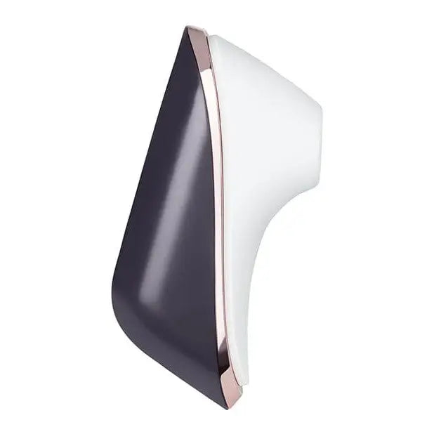 Side view of white and black chair with Satisfyer Pro Traveler Rechargeable displayed