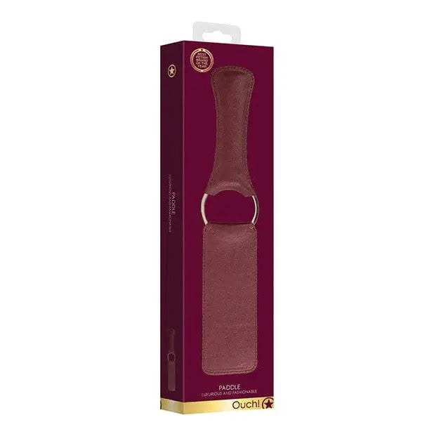 Shots Ouch Halo Paddle: Leather paddle in a burgundy box with handle & metal ring packaging