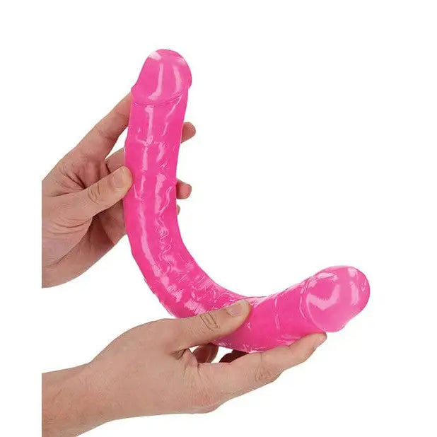 Hands holding Shots Realrock 15’ Double Dong Glow In The Dark pink double-ended sex toy