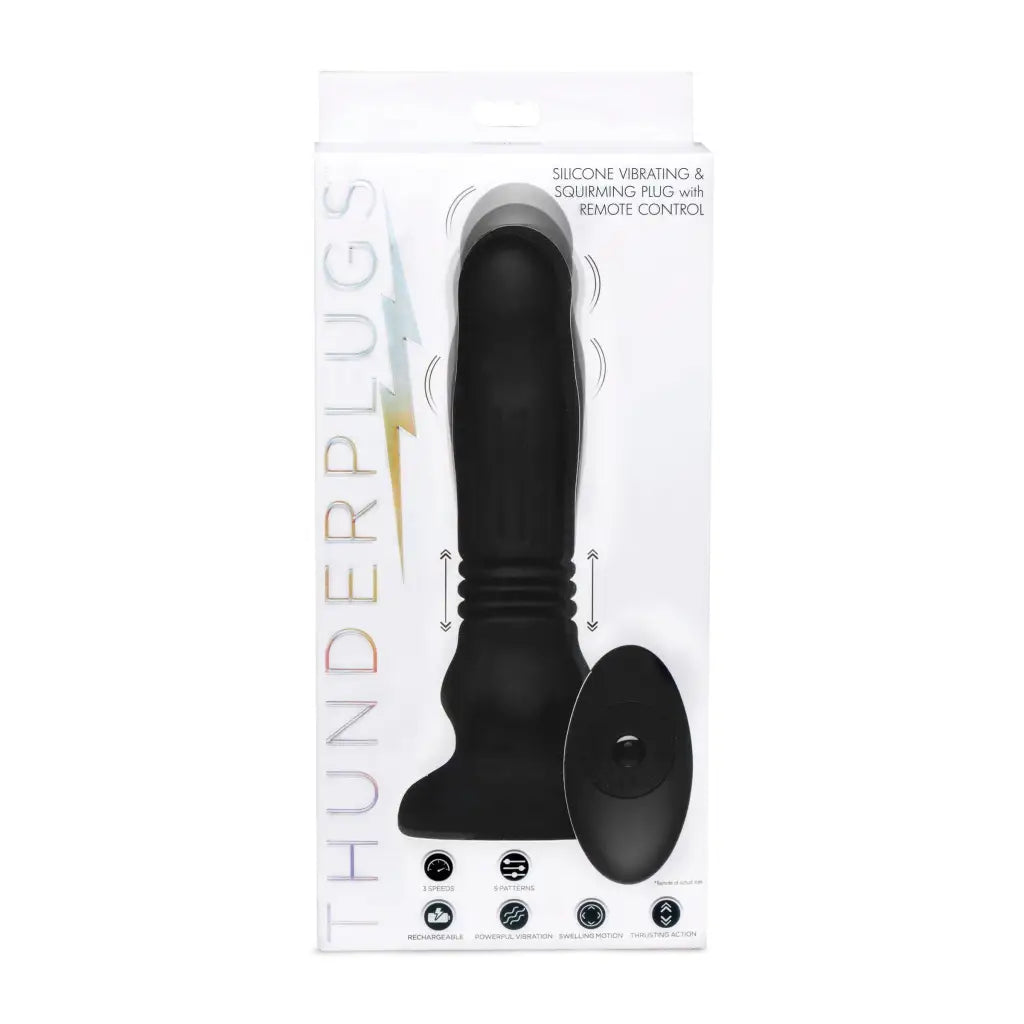 Close-up of a black silicone swelling and thrusting plug with remote control and spoon