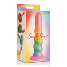 Close up of Simply Sweet Zigzag Silicone Dildo 6.5in Rainbow box with candy inside