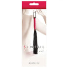 Pink-handled black leather whip packaged as ’Sinful Vinyl and Leather Whip’ adult novelty product