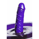 Purple silicone vibrating dildo emerging from liquid, featured on ride inflatable seat