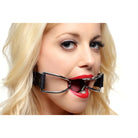 Blonde-haired person with red lipstick wearing a Spider Open Mouth Gag or dental retractor