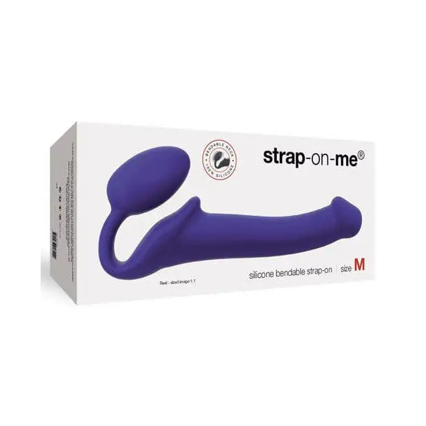 The Strap-On-Me non-vibrating strap on with a vibrating device shown in its box