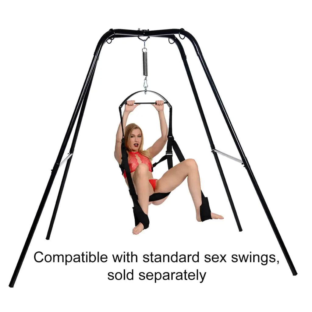 Woman in red bikini top enjoying STRICT Extreme Sling And Swing Stand in a sunny outdoor setting