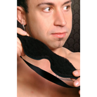 Man wearing a black tie and modeling the Strict Leather Black Fleece Lined Blindfold