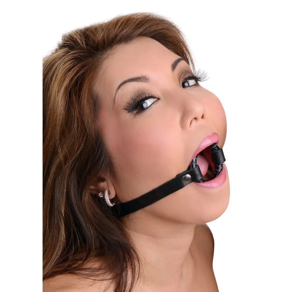 Woman with leather ring gag, long brown hair, and makeup - Strict Leather Ring Gag