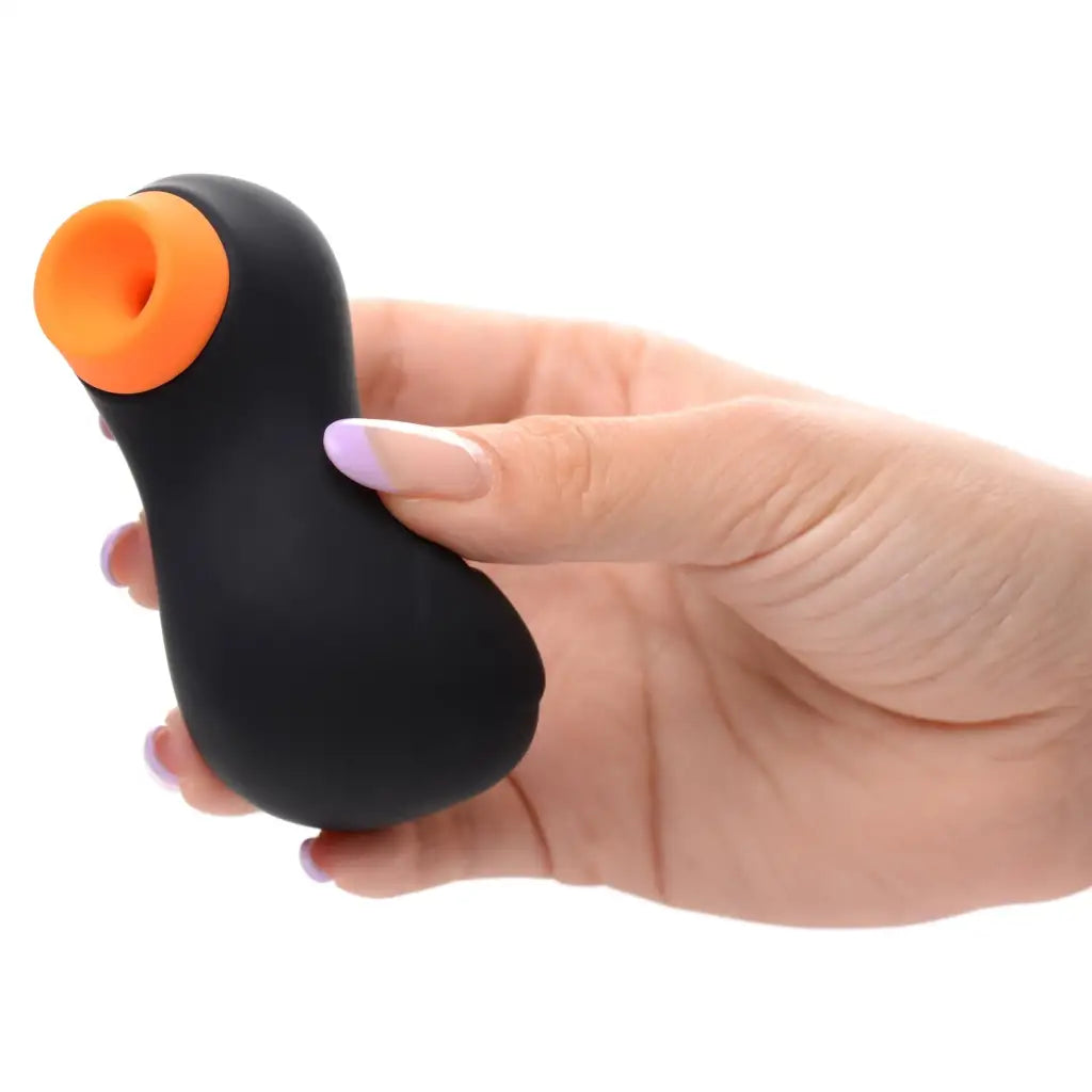 Sucky Ducky clitoral stimulator: Black handheld device with orange circular opening