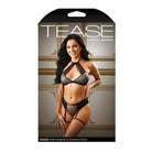 Lingerie packaging: woman modeling ’Tease Logan’ metallic lace halter top with gartered panty