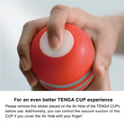 A person holding a red TENGA Air Flow CUP with a white cap, disposable masturbation sleeve