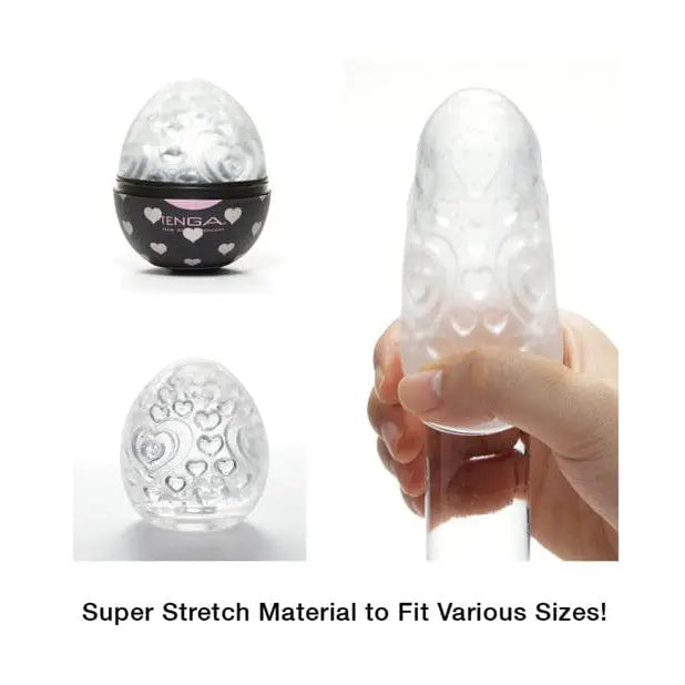 Hand holding a clear glass TENGA EGG - Lovers, a disposable masturbation sleeve