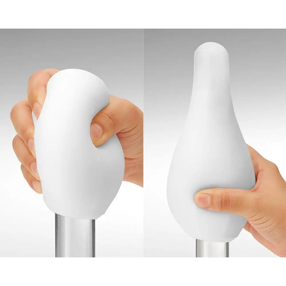 Hand holding Tenga Geo Coral Masturbator with white handle for ultimate pleasure